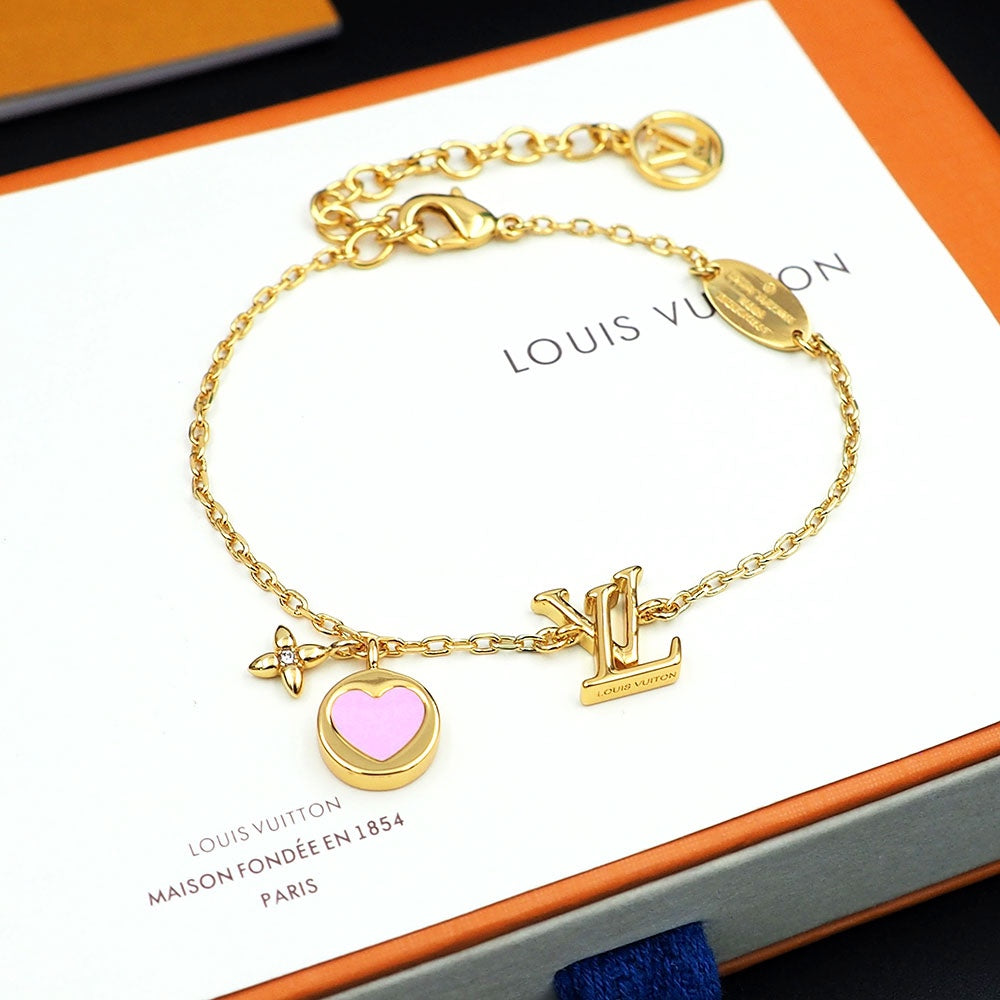 Gold bracelet with charms on a Louis Vuitton card
